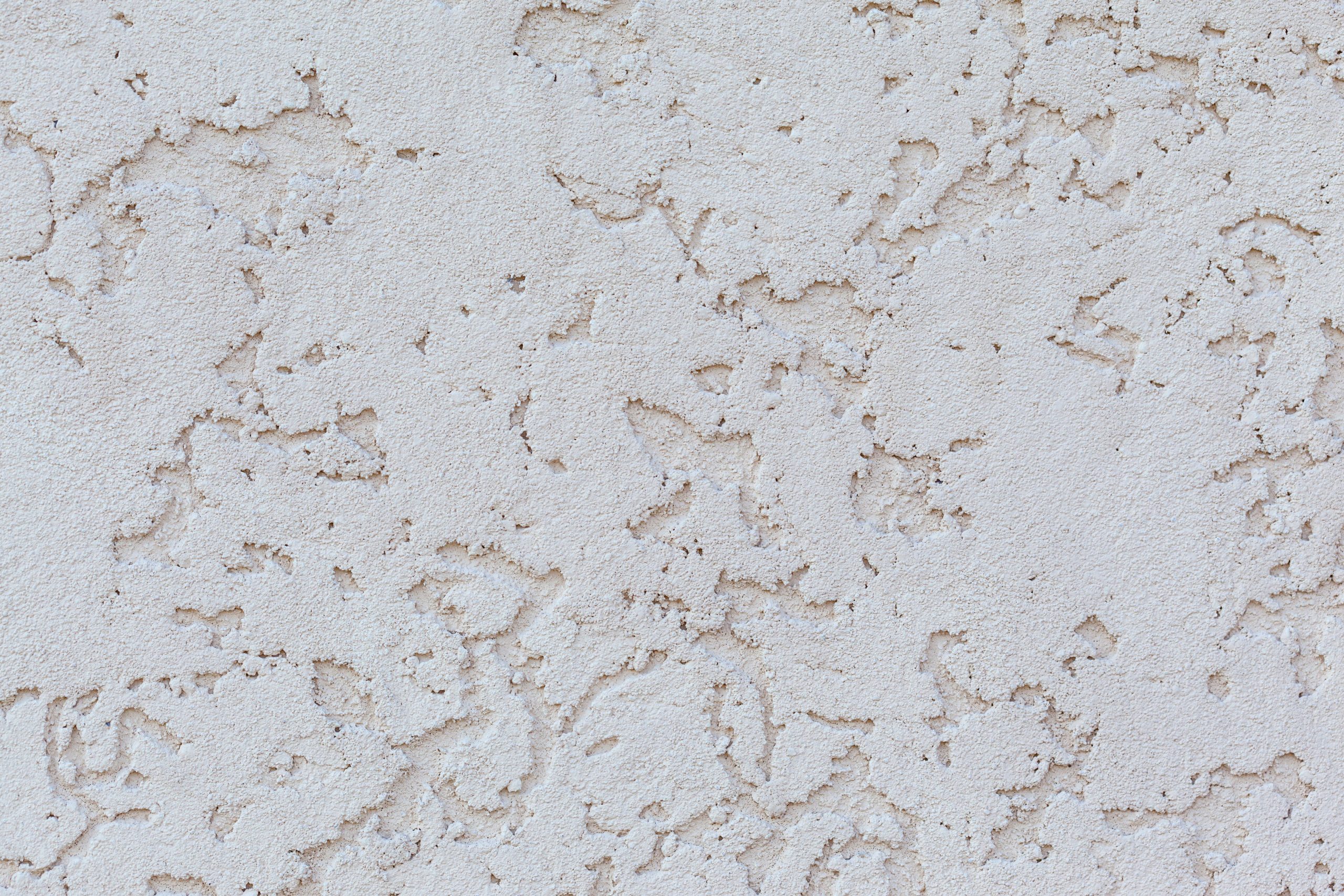 Mur enduit blanc plâtre trous porosité